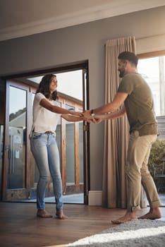 Romance comes at the most random moments. a happy young couple dancing together at home