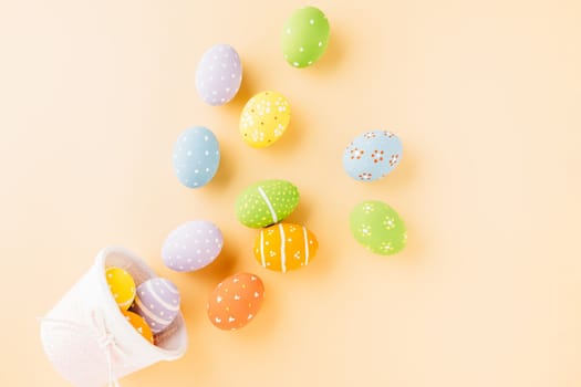 Top view easter eggs in basket filled fall down spread isolated on pastel background, Happy Easter Day, Creative composition banner web design holiday background, flat lay top view