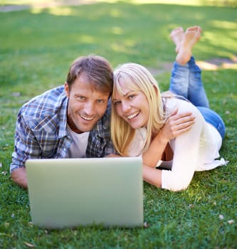 This park has everything Wifi included. Portrait of an attractive couple using a laptop outdoors