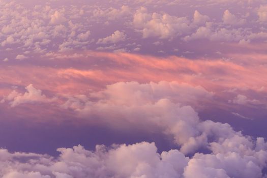 Looking down on pink clouds at sunrise from high elevation. High quality photo