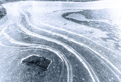 Black and white abstract image features a close-up view of an icy surface, creating a textured and visually interesting background with ice suitable for a variety of design projects. High quality photo