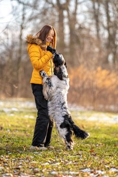 young teenage girl plays with her dog in nature. High quality photo