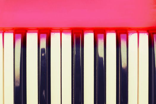 a set of keys on a piano or similar musical instrument. White and black musical keys of piano synthesizer with space for text.