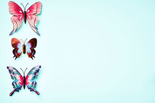 a pad of paper for writing, drawing on and advertise. Multicolored variegated butterflies isolated on emerald green lime