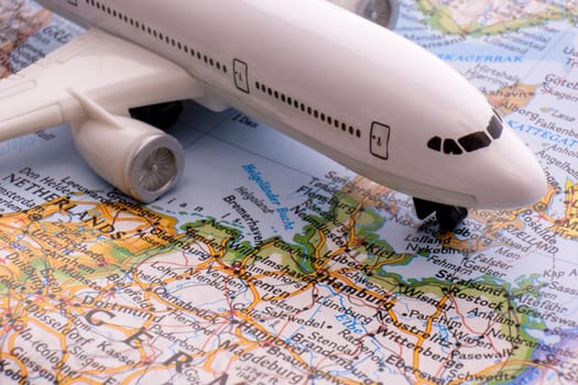 Close up of map with miniature passenger plane highlighting Hamburg, Germany through selective focus, shallow depth of field, background blur. High quality photo