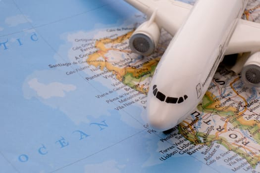 Close up of a miniature passenger plane on a colorful map highlighting Lisbon, Portugal through selective focus, background blur. High quality photo
