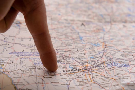 Close up of finger pointing to San Antonio, Texas with shallow depth of field, background blur. Concept geopolitics. High quality photo