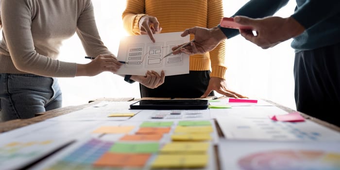 Close up view of brainstorm team of creative Web Graphic Designer ux developer and ui designer brainstorming about mobile app interface wireframe design.