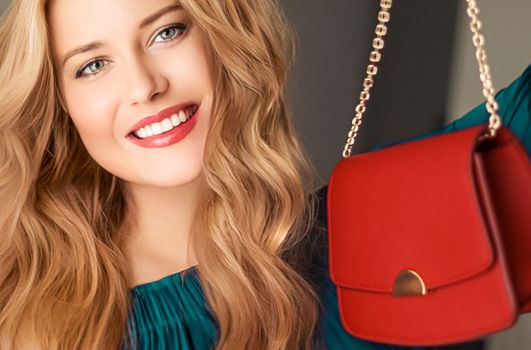 Fashion and accessories, happy beautiful woman holding small red handbag with golden details as stylish accessory and luxury shopping concept