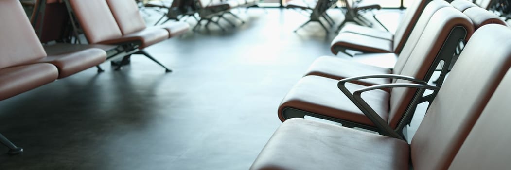 Empty terminal at airport waiting area at gate and air business. Brown leather chair at airport