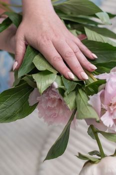 girl's hands with a beautiful pink manicure design, pastel color, gently, flowers in spring. High quality photo