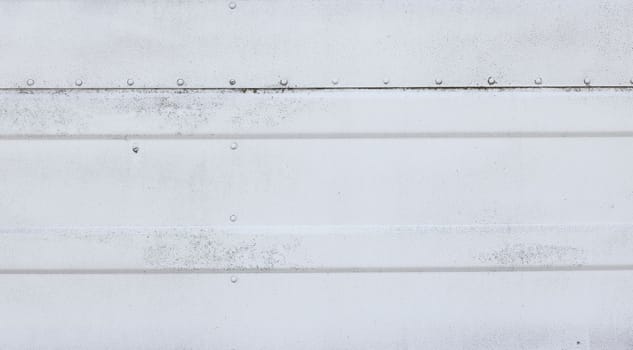 Grunge weathered white painted metal sheet wall or fence background texture