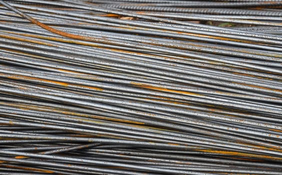 Pile of metal fitting or armature rebars, partly corroded outdoors
