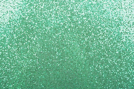 Abstract background texture of shiny turquoise teal glitter pattern with light gradient