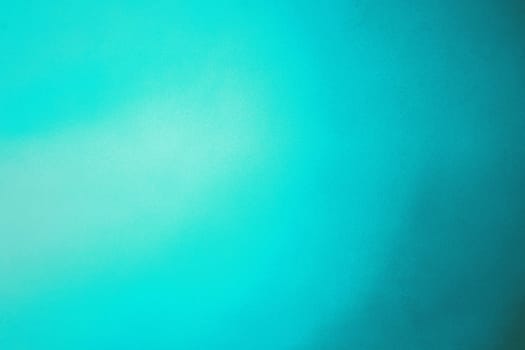 Abstract colorful background with grunge noise grain texture and vivid color gradient of teal and blue