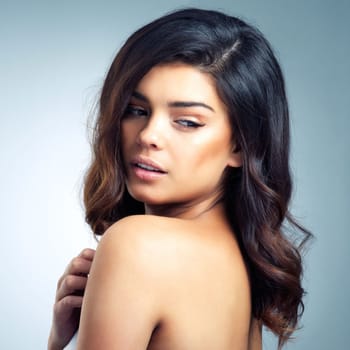 Shes everything that beauty aspires to be. Studio shot of a beautiful young woman posing against a gray background