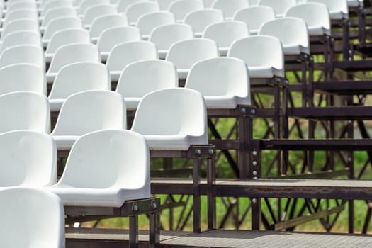 Seats of tribune on sport stadium. Concept of fans, chairs for audience, cultural environment concept. mpty seats, modern stadium