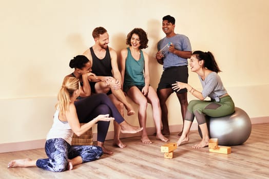 Theres nobody like a yoga buddy. a group of young men and women hanging out in yoga class