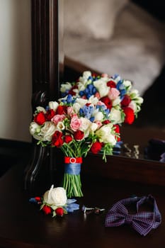 wedding bouquet with roses and boutonniere.The decor at the wedding.