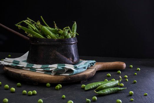 View of delicious green peas inside a iron old pot