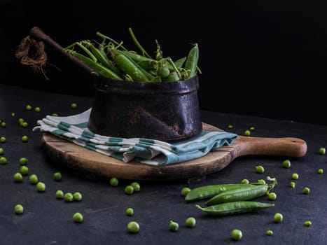 View of delicious green peas inside a iron old pot