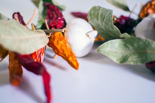 Close up of Galrlics, chili peppers, bay leaves