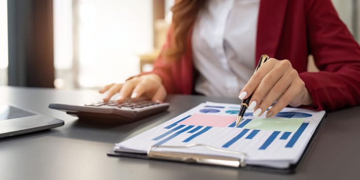 Accountant woman working with calculator and laptop computer, Tax deduction planning concept. Business woman calculating business balance prepare tax reduction.