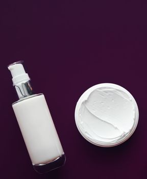 Beauty cosmetics and skincare product on purple background, flatlay.