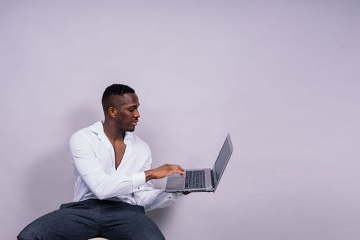 African American millennial businessman isolated on a studio background, successful male formal suit