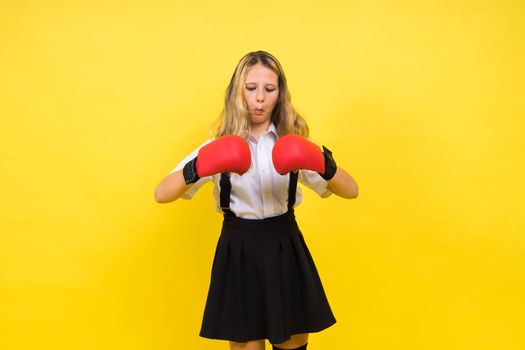 Little girl wearing red boxing gloves, studio shot, sport conception