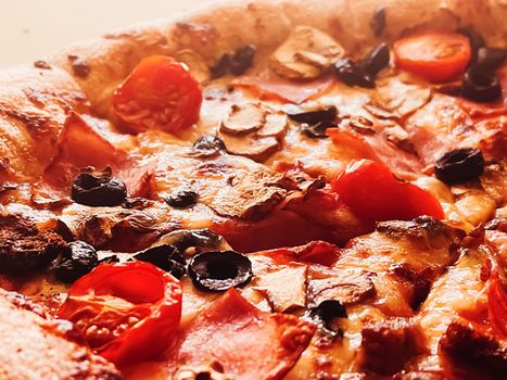 Pizza capriciosa in pizzeria, food background close-up