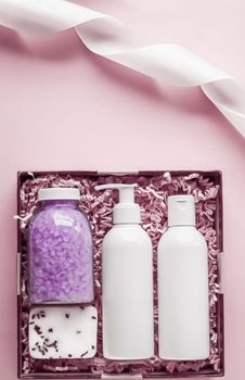 Beauty box subscription package, luxury skincare and body care products, milk lotion, bath salt, soap, shower gel as flat lay on pink background, spa cosmetics as holiday gift, online shopping delivery, flatlay.