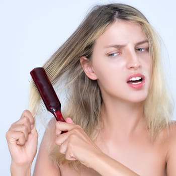 Closeup alluring portrait of beauty cosmetic clean skin woman having brittle dry hair problem. Grimacing frustrated sad facial expression in isolated background. Damaged and hair loss concept.