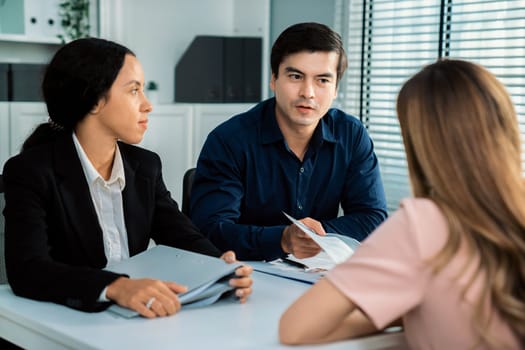 A young female asian candidate tries to impress her interviewer by being competent. International company, multicultural environment in workplace.