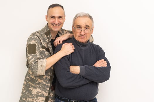 Portrait of army man with parents, elderly father and military son