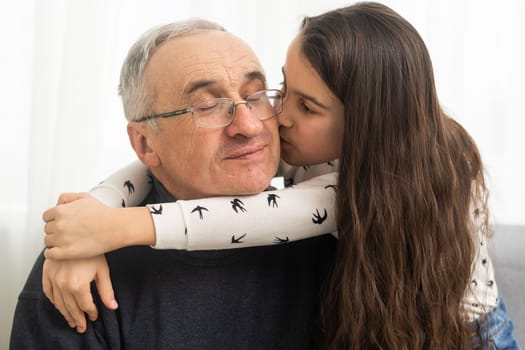 Elderly eighty plus year old man with granddaughter in a home setting