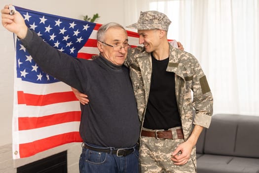 an elderly father and a military son saluting American flag.