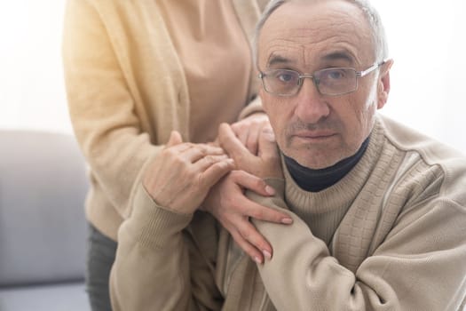 Young woman holding senior man hands, closeup.