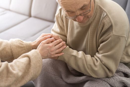 Two people holding hand together. elderly man and support woman.