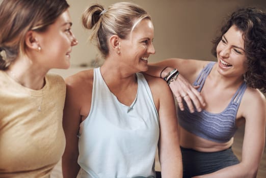 Friends who do yoga together stick together. a young group of women sitting together and bonding during an indoor yoga session