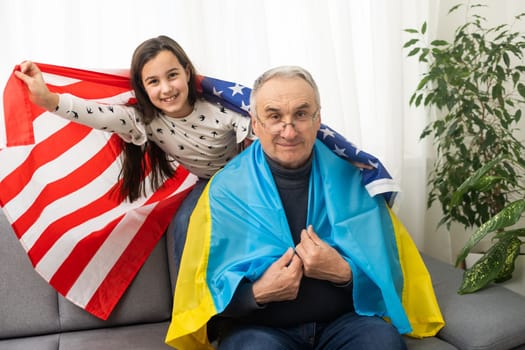 grandfather and granddaughter with the flags of the USA and Ukraine.