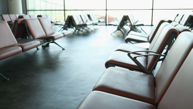 Empty terminal at airport waiting area at gate and air business. Brown leather chair at airport