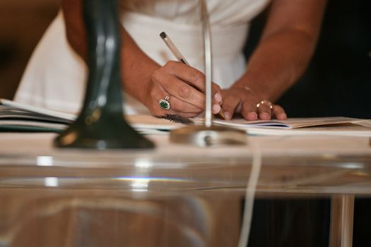 A bride signs the marriage registration documents
