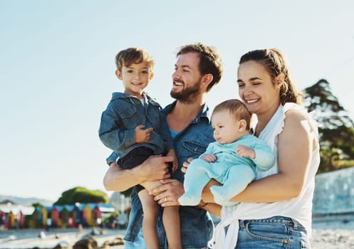 Always keep family beach days in your heart. a young family spending quality time at the beach