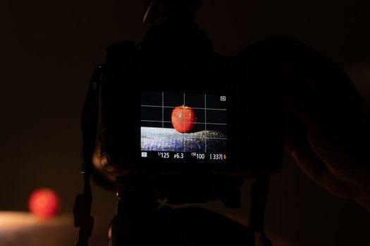Camera on tripod for food photographing in a dark studio