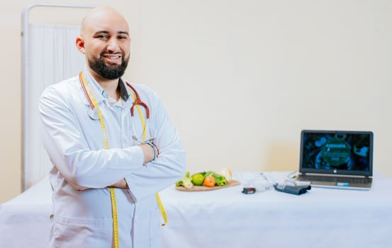 Portrait of smiling male nutritionist at his workplace. Smiling nutritionist doctor with crossed arms in her office. Portrait of smiling professional nutritionist.