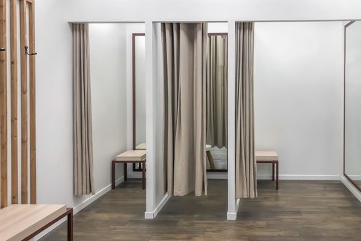 A row of dressing booths for trying on clothes in a store
