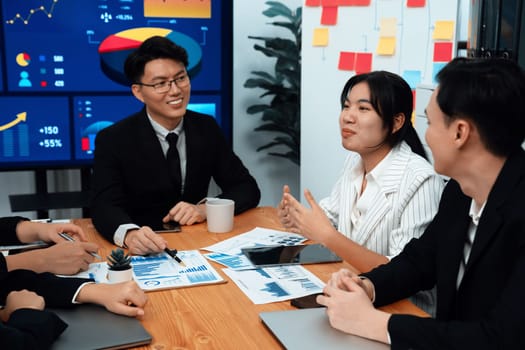 Business team of financial data analysis meeting with business intelligence, report paper and dashboard on laptop for marketing strategy. Business people working together to promote harmony in office.