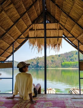 Asian women visit Huai Krathing lake in North Eastern Thailand Isaan region famous for its floating bamboo rafts where you can have lunch or dinner in the middle of the lake.