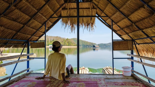 Asian women visit Huai Krathing lake in North Eastern Thailand Isaan region famous for its floating bamboo rafts where you can have lunch or dinner in the middle of the lake.